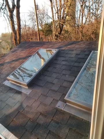 Two skylights installed on an asphalt shingle roof, demonstrating RainWise skylight installation and waterproof flashing for leak prevention in Portland homes