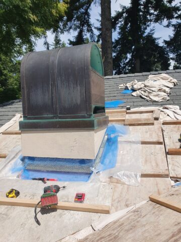 Freshly installed plywood roof decking prepared for underlayment and shingle placement during roof replacement