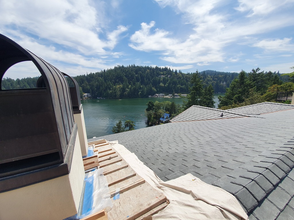 Close-up of chimney waterproofing and flashing installation during roof repair to prevent leaks and moisture damage